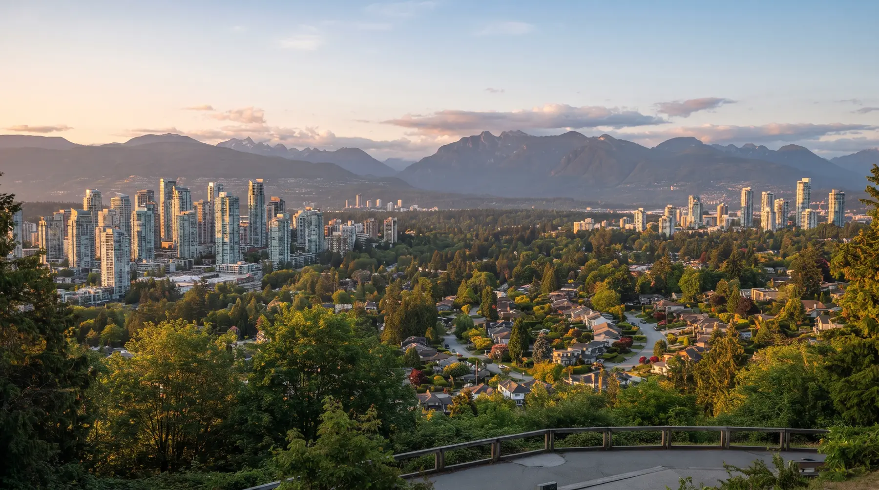 Burnaby skyline with Metrotown and Brentwood towers above tree-covered neighbourhoods and North Shore mountains